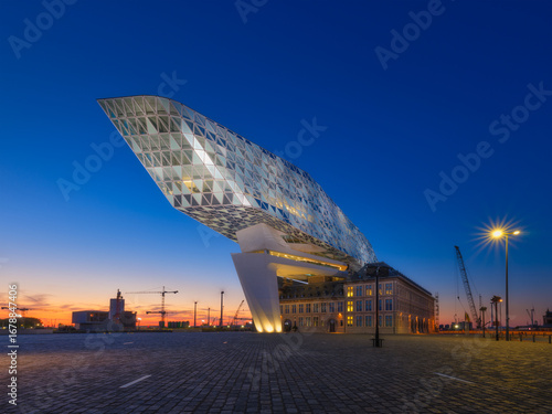 Port Authority of Port of Antwerp-Bruges. Modern main building of the port in Antwerp, Belgium. Evening urban architectural landscape. View during sunset. Background, postcard, wallpaper.