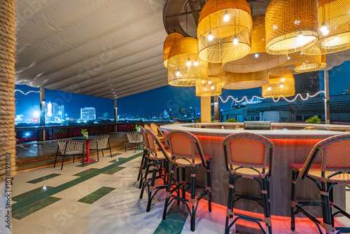 Contemporary roof top bar and cityscape view at twilight.