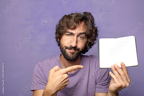 young adult bearded man with a poket notebook