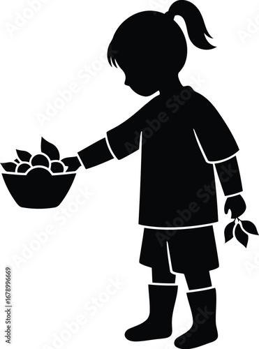 Silhouette of a young girl in boots picking fruit into a bowl.