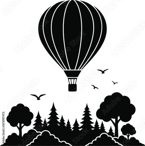 Black silhouette of hot air balloon over a forest.