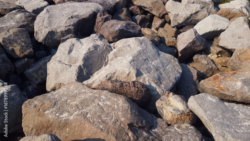 Riprap stones installed along the beach form a dike to hold back ocean waves.