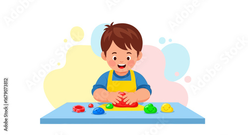 A cheerful little boy is playing with modeling clay at a table, creative activity