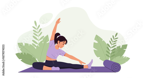 Young woman practicing yoga on a mat in front of leaves performing a stretch exercise