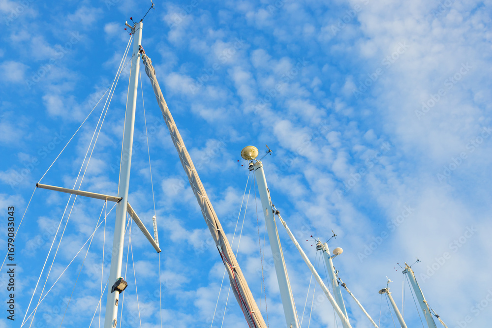 Fototapeta premium Wind indicator mounted on sailboat mast against sky. Sailing equipment showing wind direction and speed. Essential gear for navigation, regatta, and cruising