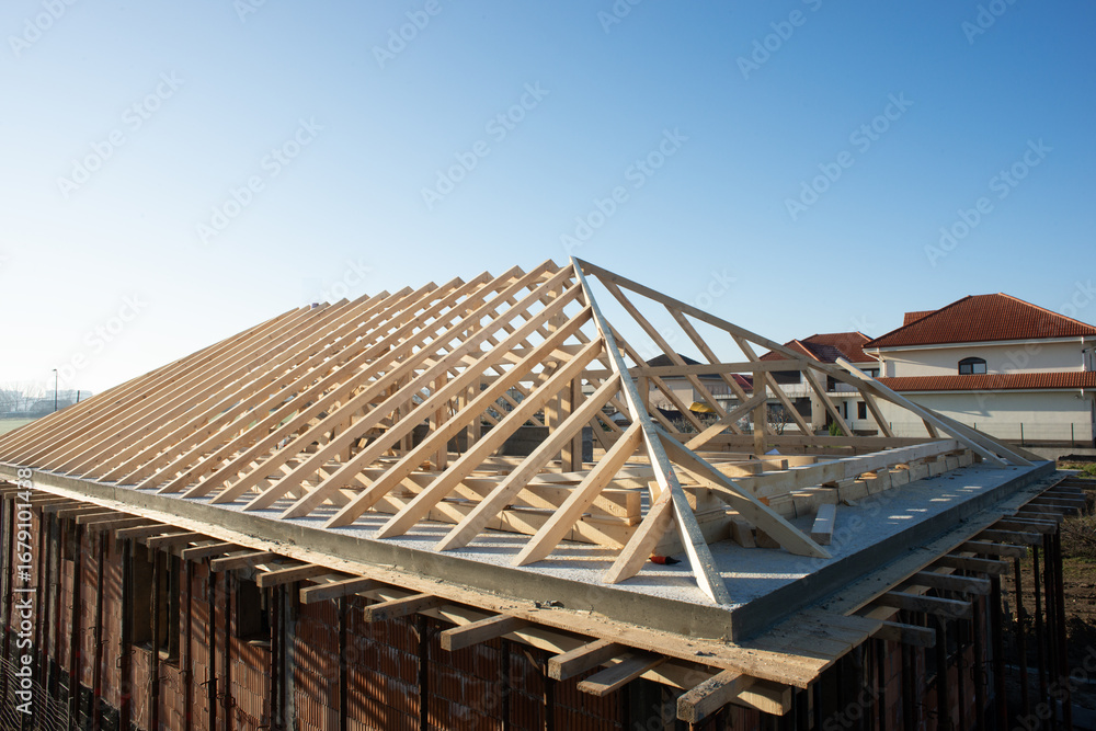 Fototapeta premium wooden rooftop of a house on a sunny day with clear blue sky