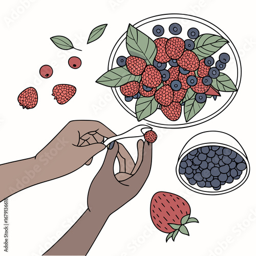 Hands preparing a colorful assortment of fresh raspberries and blueberries with a strawberry and leaves scattered around