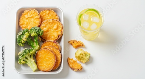Healthy lunch box with sweet potato fries, broccoli and lemonade