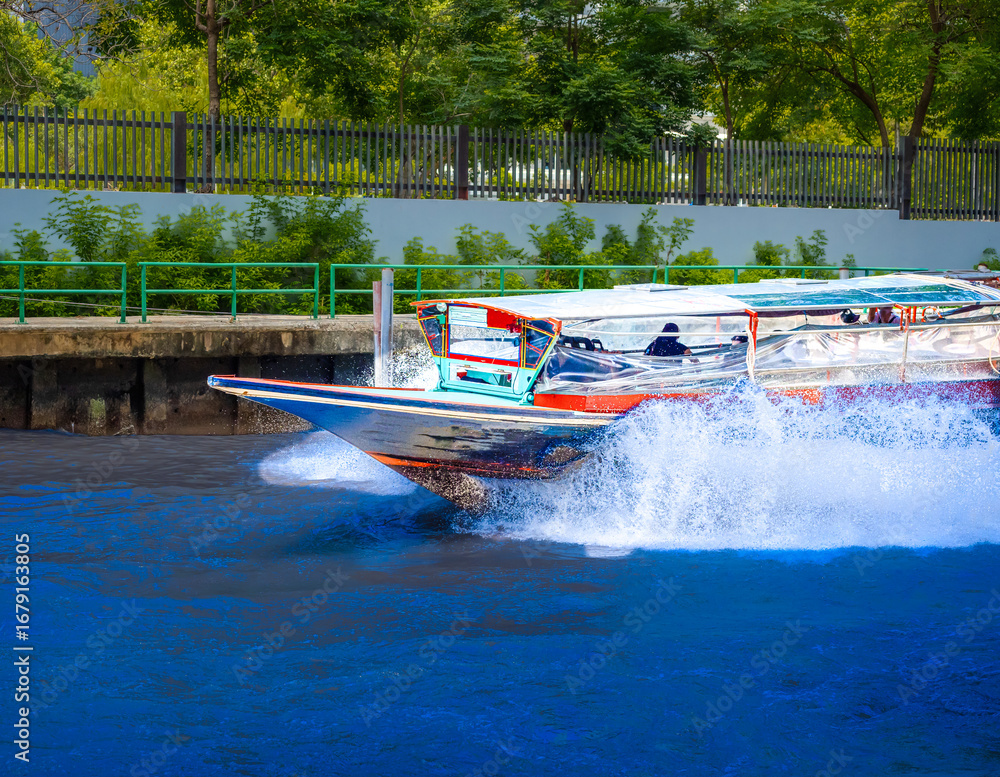 Fototapeta premium Ferry boat going through a Canal Khlong in Thai running from Asoke Soi 21 Sukhumvit Rd NANA to Siam and Platunam in BKK Bangkok Thailand