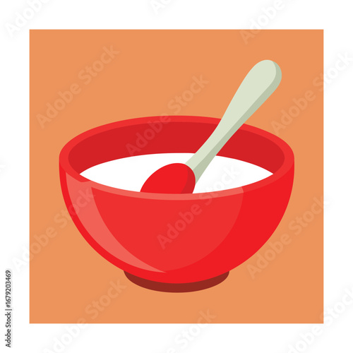 Red bowl with white contents and spoon on orange background