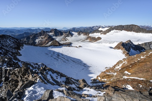 Wallpaper Mural Narrow rocky ridge at the Wilder Freiger summit, picturesque high mountain landscape with snow, view of Übeltalferner glacier and rocky mountain peaks Königshofspitz and Sonklarspitze, Stubai Alps, South Tyrol, Italy Torontodigital.ca