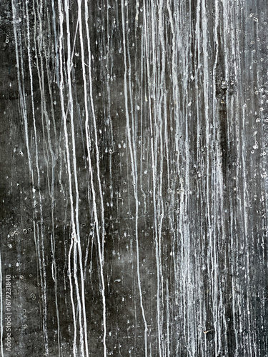 Dark weathered slate wall with white streaks and a faint marks useful background