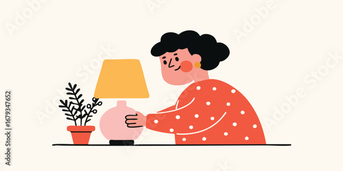 A cheerful lady turns on a desk lamp next to a potted plant on a minimalist table. The setting suggests the warmth and comfort of a cozy, inviting space. 
