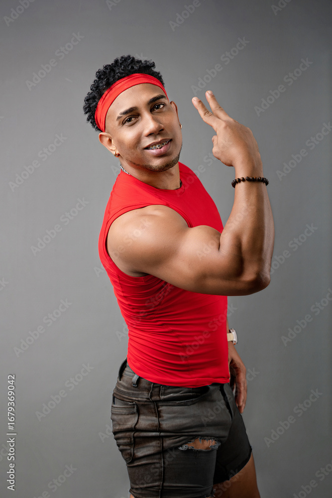 Naklejka premium Young fitness trainer with a positive attitude, healthy athletic man wearing a red T-shirt. Sports concept