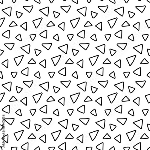 Abstract seamless pattern with scattered black triangles on a white background, modern graphic design