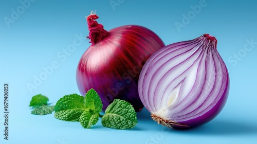 Raw Red Onion with Mint Leaves on Blue Background for Culinary Use