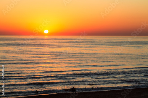 Caspian Sea at sunset with the sun and orange sky, Derbent, Dagestan, Russia