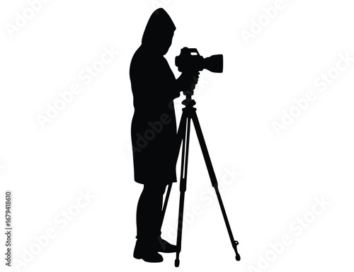 Dark silhouette of a person holding a camera