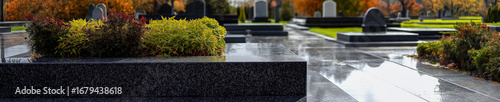 Modern cemetery with polished granite tombstones and neatly arranged greenery. A tranquil and dignified place for remembrance and reflection.