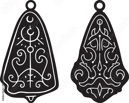 Two ornate tribal amulet pendants with intricate patterns isolated on white background silhouette