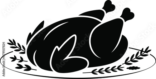 Black silhouette of a roasted whole chicken on a decorative plate