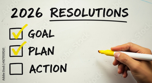 A person checks off their 2026 resolutions for goal and plans on a whiteboard, a perfect motivational image for setting and achieving new year's objectives