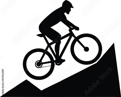 Silhouette of a mountain biker riding downhill on a steep slope