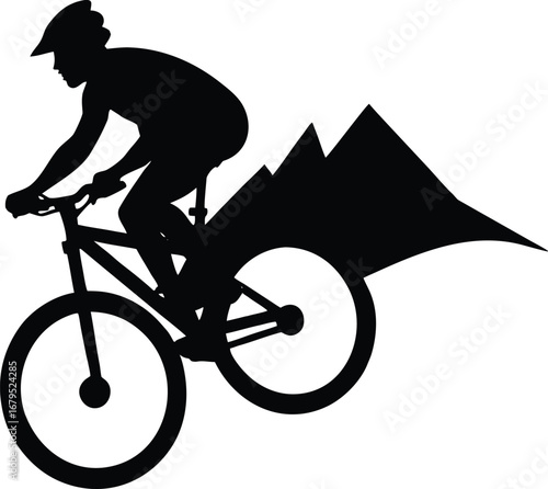 Silhouette of a mountain biker riding downhill with mountains in the background