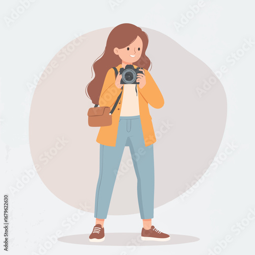 A young woman photographer holds her camera, ready to capture a moment.  She's dressed casually and carries a camera bag.
