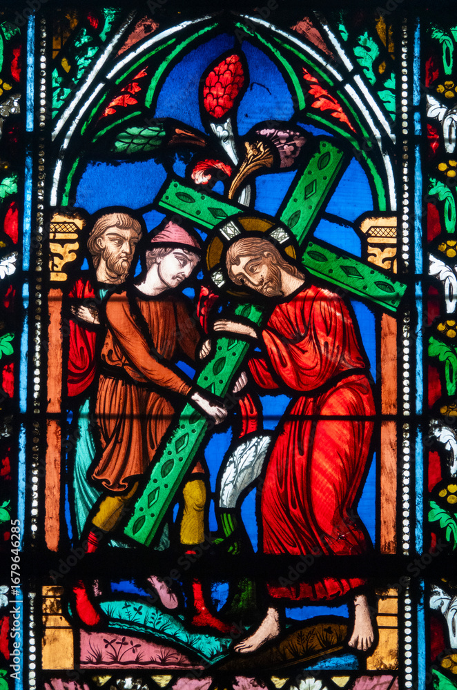 Fototapeta premium Stained glass (19th century) of the Way of the Cross. Fifth station: Simon of Cyrene helps Jesus carry his cross.
