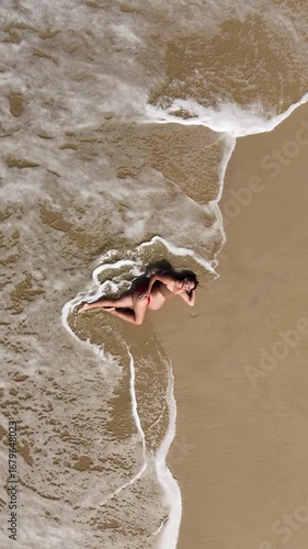Pregnant Woman on Sandy Beach Vertical 9x16 Drone Zoom Out 4K