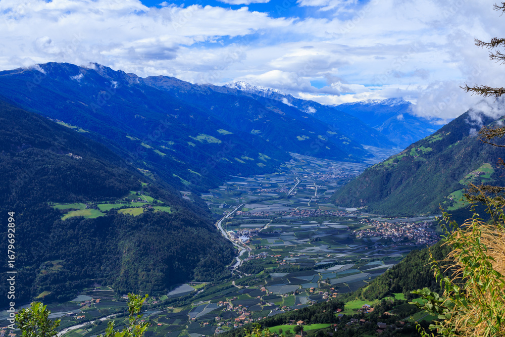 Obraz premium View from Hochmuth mountain station towards valley Etschtal with mountain panorama and summit Hasenöhrl in South Tyrol, Italy