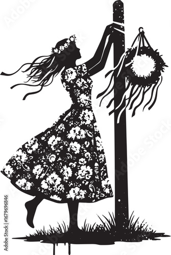 Silhouette of woman adorning a maypole with floral wreath in mon