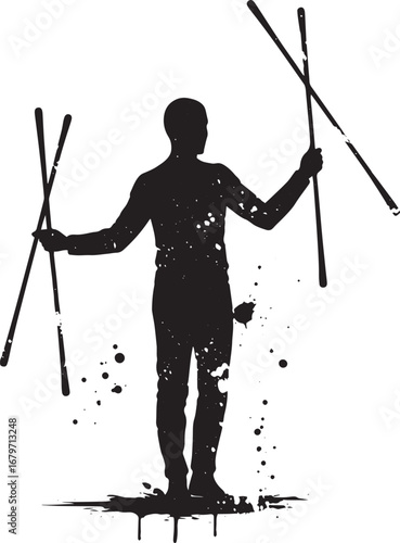 Silhouette of a performance artist dynamically balancing sticks