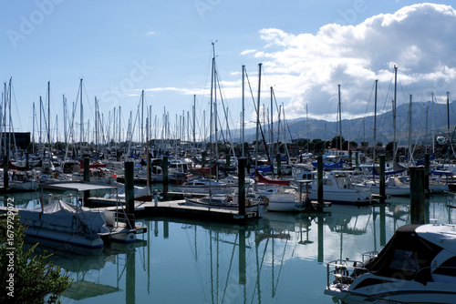 Luxury yachts and private sailing boats in marina in the port of Nelson, New Zealand during sunny day.