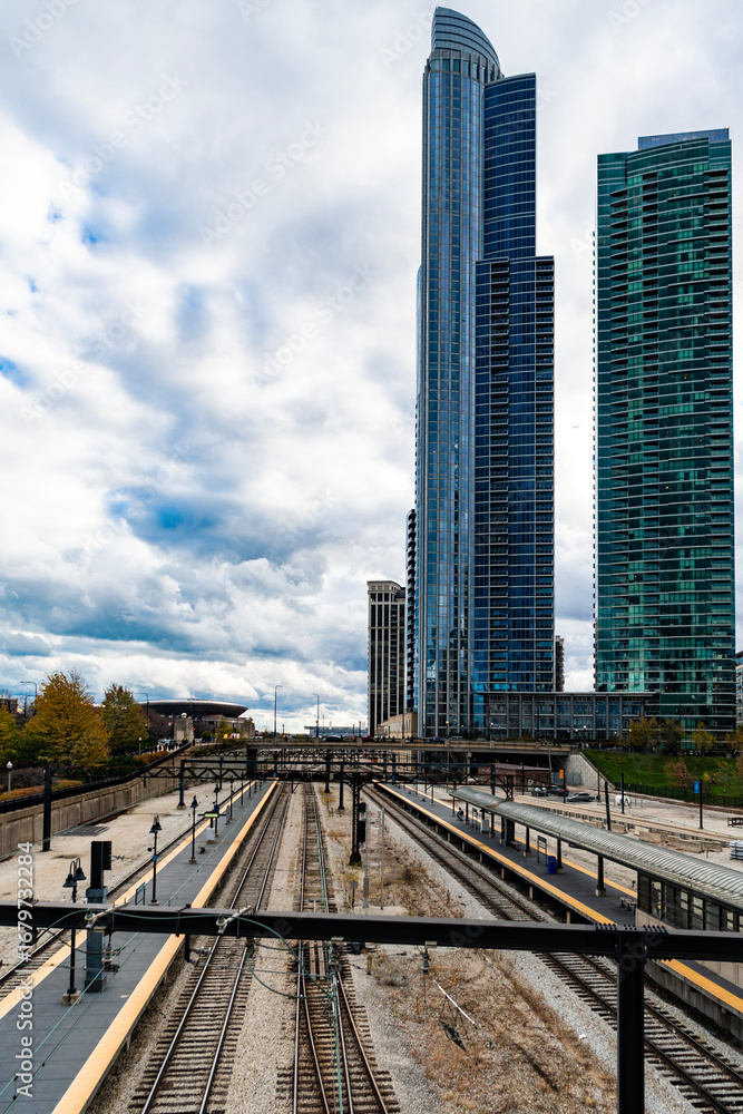 Naklejka premium Chicago, Illinois, USA - November 10, 2024: Railroad urban transport. Urban train rail. Rail for metro. Railway station with city skyscraper cityscape. Urban modern cityscape. Metro railway station