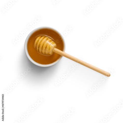 honey dripping from a wooden dipper