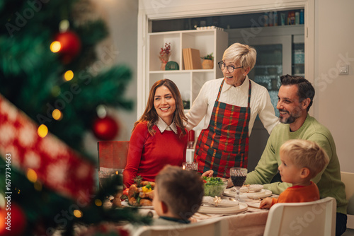 Vászonkép Happy family enjoying christmas dinner at home