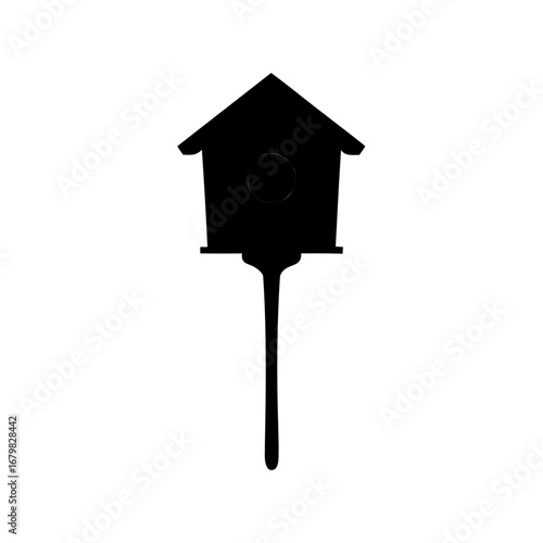 Silhouette of a whimsical wooden birdhouse on a post against white background
