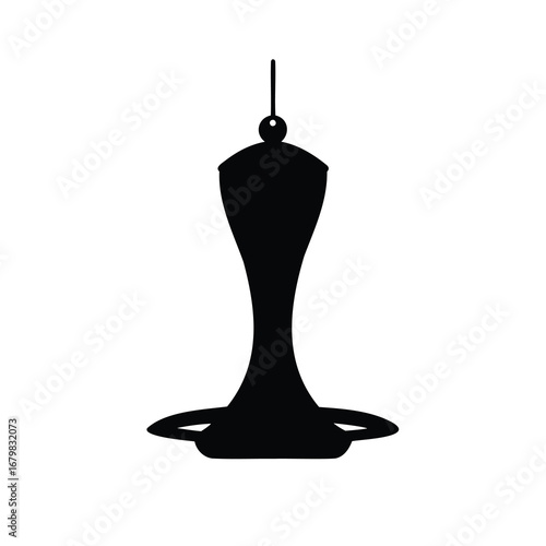 Silhouette of a hummingbird feeder hanging from a string, casting a shadow