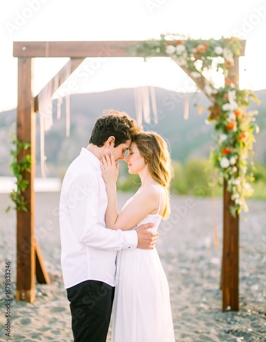 Couple embraces at beach ceremony