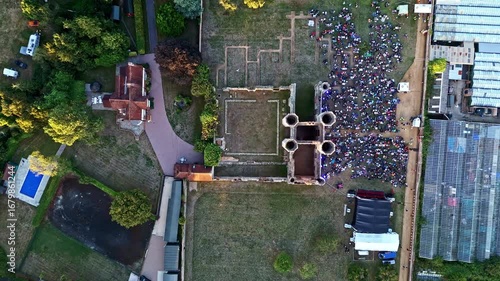 aerial Birds Eye drone shot moving down over ancient old English Titchfield abbey ruins in countryside in summer at sunset