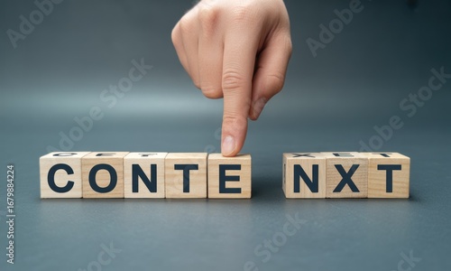 A hand's finger is positioned over the letter 'X' of the word 