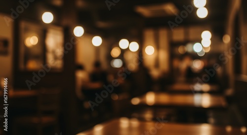 A blurred image of a cozy coffee shop at night, with warm lighting creating a welcoming atmosphere