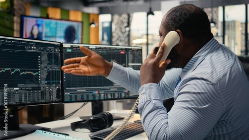 Photos Distressed brokerage firm trader making phone calls to clients in response to Black Swan event shock