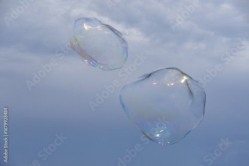 Huge bubble with blue sky and white cloud background
