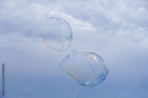 Huge bubble with blue sky and white cloud background
