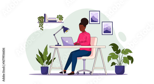 Productive young Black woman working on her laptop at a cozy home office desk. Illustrates remote work, education, and modern lifestyle.
