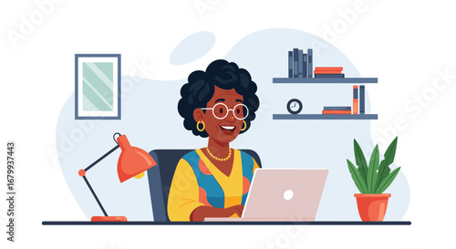 Happy mature Black woman working on a laptop from her home office, embodying productivity and online connectivity. Ideal for business, education, or remote work concepts.