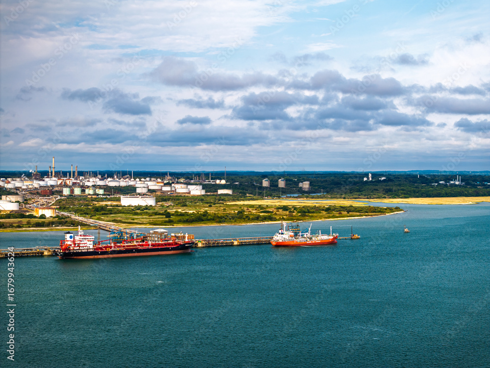 Obraz premium Gas tankers over refinery Esso Oil Terminal from drone, Southampton, Hampshire, England, Europe